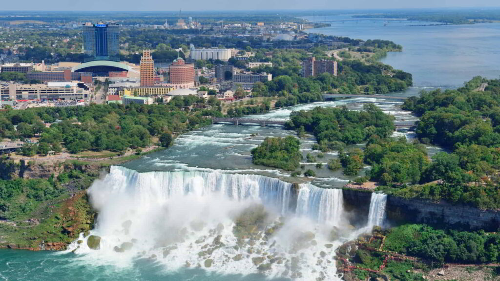 Niagara falls closeup in the day over river with buildings