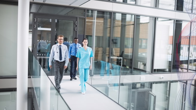 A group of people walking in a hospital hallway