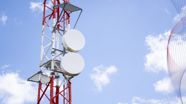 Telecommunications antenna against cloudy sky in the background