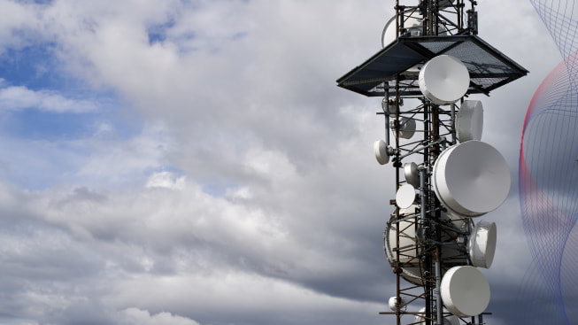 Telecommunications tower against cloudy sky