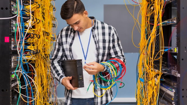 A person holding server component in a server room