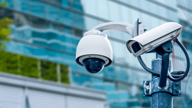 Security cameras with a residential building in the background