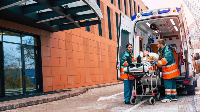 Team of doctors in the ambulance moving on a patient into the hospital during an emergency situation