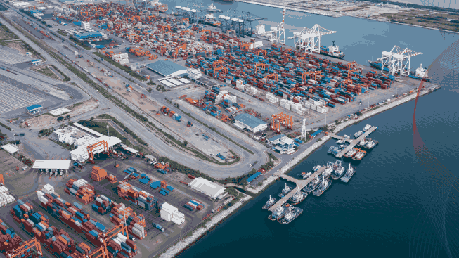 Tugboat parking in a row in sea and container shipping port background