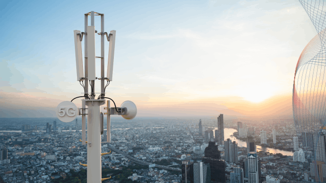 Telecommunication tower with wifi & cellular network antennas on city background