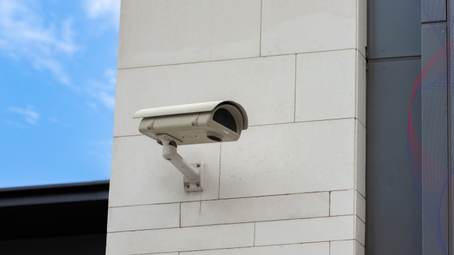 Surveillance camera built into the stone wall of the building