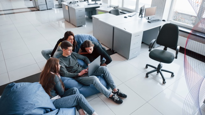 Group of young people in casual clothes working in the modern office