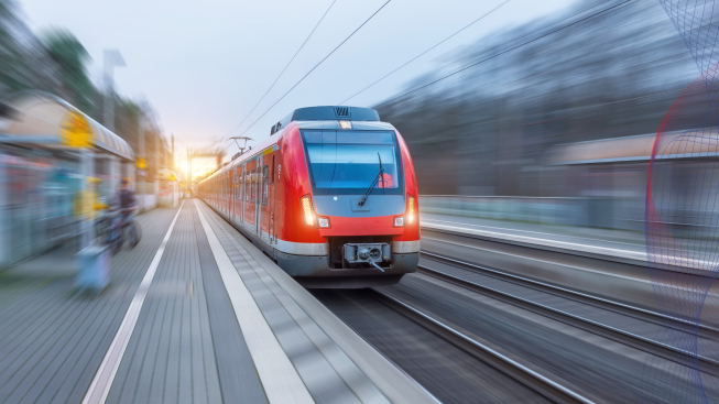 Passenger high-speed red train with motion blur in the railway station