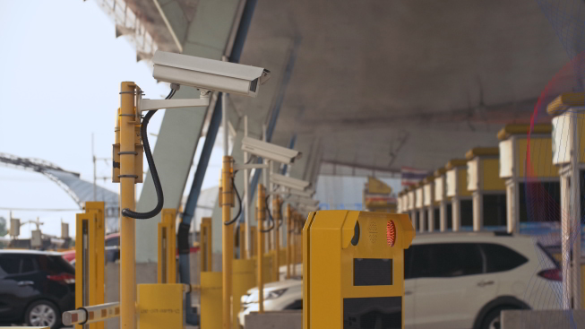 CCTV security cameras installed on a poll monitoring the road traffic